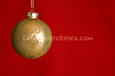 Christmas greeting card with gold ball on red horizontal