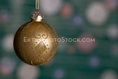 Christmas greeting card with golden yellow ball on green