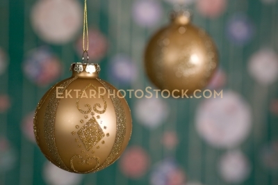 Christmas greeting card with golden yellow balls balls on green