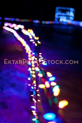 Fence decorated with colorful Christmas lights