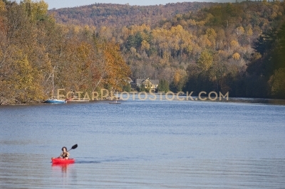 Kayaker paddling on Gatineau river near Wakefield at Fall