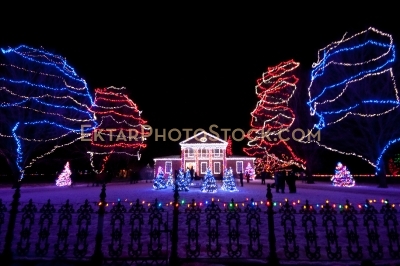 Mansion Front yard decorated with colorful Christmas lights fence