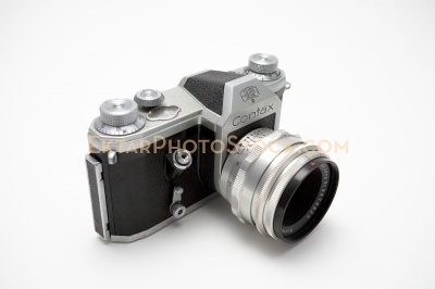 Old film SLR camera isolated on white side view